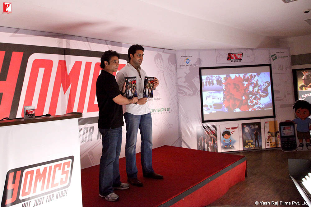 Uday Chopra and Abhishek Bachchan showcasing the comics at the YOMICS press conference 