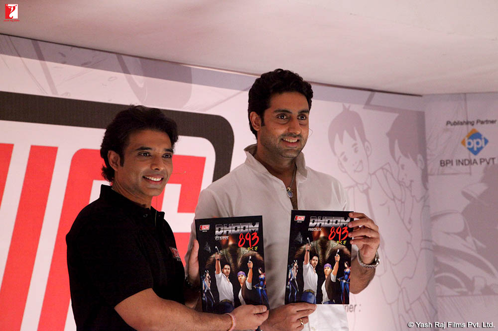 Uday Chopra and Abhishek Bachchan showcasing the comics at the YOMICS press conference 